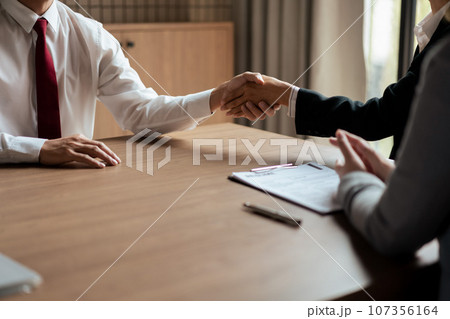 HR manager woman shaking hand and congratulation with male candidate after successful interviewing 107356164