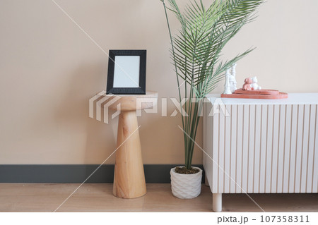 Mockup photo frame on the wall of living room, Interior with furniture 107358311