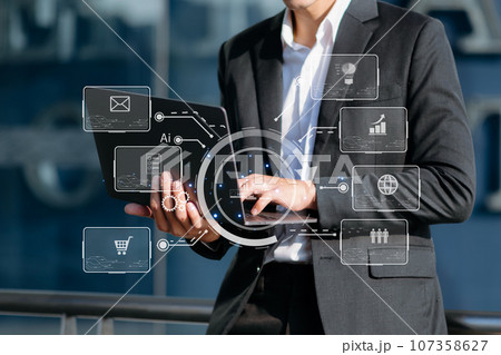 Digital marketing media in virtual screen.businessman hand working with mobile phone and modern compute with VR icon diagram at office 107358627