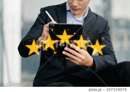Customer or client the stars to complete five stars. with copy space. giving a five star rating. Service rating, satisfaction concept. in business center.. 107359078