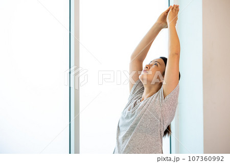 Asian young female adult standing for practice Yoga pose Warrior I 107360992