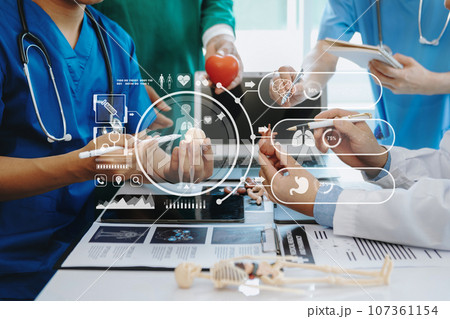 Medical technology network team meeting concept. Doctor hand working with smart phone modern digital tablet and laptop computer with graphics chart interface, with virtual icon diagram Medical technology network team meeting concept. Doctor hand working with smart phone modern digital tablet and laptop computer with graphics chart interface, with virtual icon diagram 107361154