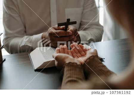 Two people reading and study bible in home and pray together.Studying the Word Of God \. Two people reading and study bible in home and pray together.Studying the Word Of God \. 107361192