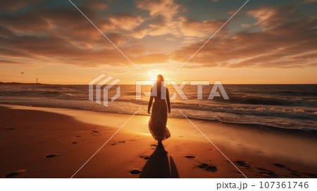 Radiant Horizon concept, A person standing on a beach during sunrise, facing the new day 107361746