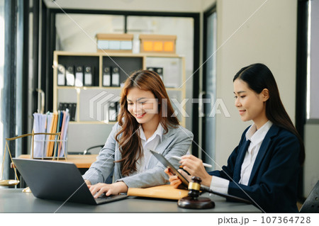 business Asian people and lawyers discussing contract papers sitting at the table. Concepts of law, advice, legal services. 107364728