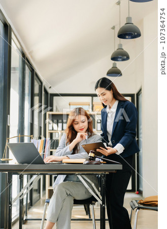 Business law concept, Lawyer business lawyers are consulting lawyers for women entrepreneurs to file copyright lawsuit with laptop and tablet 107364754