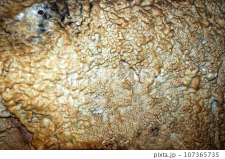 Crimea, Russia. Stalactites, stalagmites on the walls of the Emine-Bair-Khosar cave. Template for design. Selective sharpness. Crimea, Russia. Stalactites, stalagmites on the walls of the Emine-Bair-Khosar cave. Template for design. Selective sharpness. 107365735