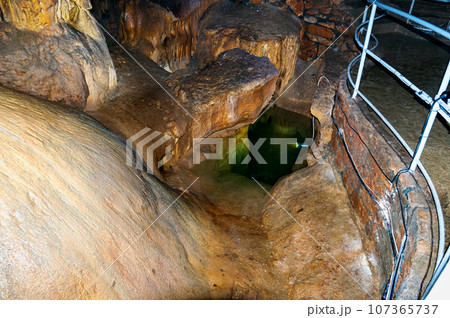 Crimea, Russia. Stalactites, stalagmites on the walls of the Emine-Bair-Khosar cave. Template for design. Selective sharpness. 107365737