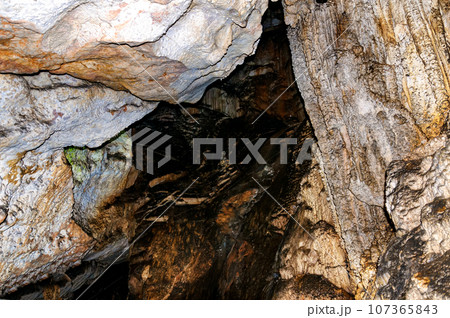 Crimea, Russia. Stalactites, stalagmites on the walls of the Emine-Bair-Khosar cave. Template for design. Selective sharpness. 107365843