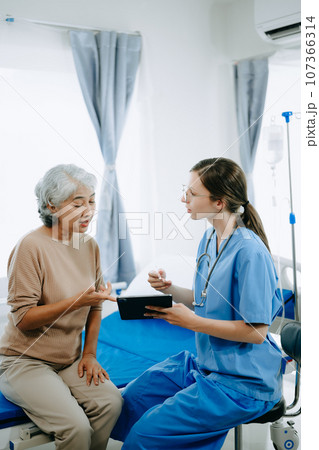 Caucasian doctor smiling take care of a young patient in hospital. Friendly nurse or therapeutic treat client Professional medical service concept. 107366314