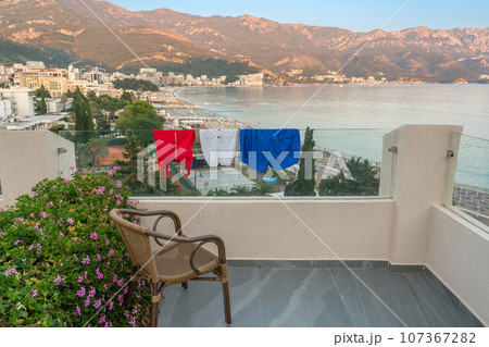 Swimsuits drying on the balcony of a modern hotel as a national flag concept 107367282