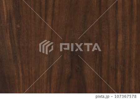 Used black walnut wood board texture with oil finish closeup 107367578