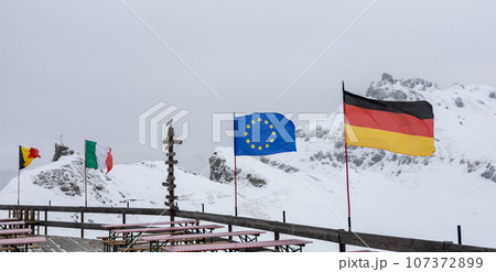 EU countries national flags against winter mountains 107372899