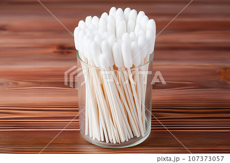 hygienic ear cotton buds in a box on a wooden countertop 107373057