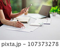 Concept of business office woman working,Businesswoman smile while working about her invesment plan with analyzing document and business investment graph data by using laptop on desk in workstation. 107373278