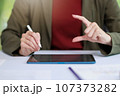 Concept of business office woman working,Businesswoman smile while working about her invesment plan with analyzing document and business investment graph data by using laptop on desk in workstation. 107373282