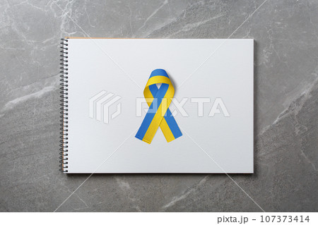 yellow and blue ribbon on notepad yellow and blue ribbon on notepad 107373414