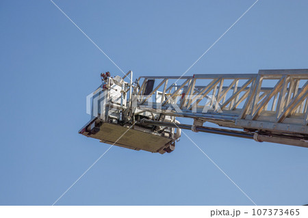 firefighter ladder nacelle platform firetruck climbing equipment on blue sky 107373465