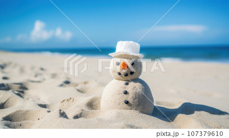 A cute snowman on the beach in bright sunlight, with the sea or ocean in the background. Merry Christmas time, greeting Card. Winter Getaway by the Sea. Beach Christmas Vacation 107379610