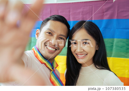 LGBTQIA friends taking selfies together with Pride flag. LGBTQIA f LGBTQIA friends taking selfies together with Pride flag. LGBTQIA f 107380535