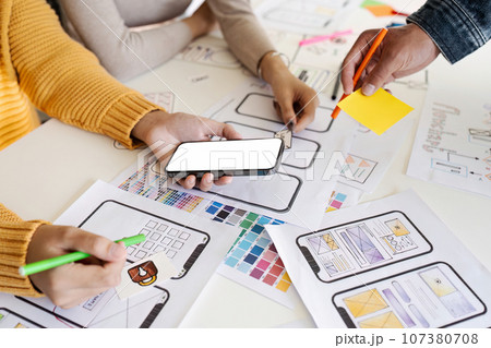 team of UI UX web designer are working together to develop mobile responsive websites. Mobile Mockup team of UI UX web designer are working together to develop mobile responsive websites. Mobile Mockup 107380708