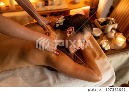 Caucasian woman customer enjoying relaxing anti-stress massage. Quiescent Caucasian woman customer enjoying relaxing anti-stress massage. Quiescent 107381041