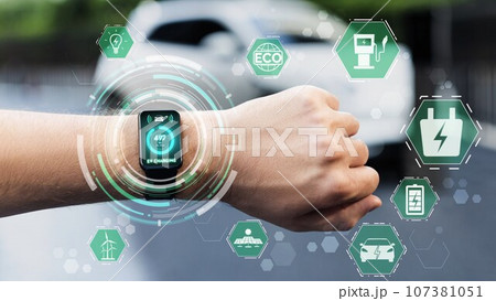 Smartwatch display eco icon pictogram hologram while EV recharge battery. Peruse Smartwatch display eco icon pictogram hologram while EV recharge battery. Peruse 107381051