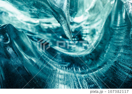 Majestic transparent ice crevasse, blue vatnajokull ice mass with cracks in iceland. Covered frost icy blocks inside wintry glacier structure tunnel, scandinavian nordic landscape. 107382117