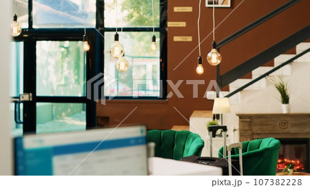 Empty hotel reception and front desk with lounge area used to check in tourists and help with room accommodations. Luxurious resort lobby with modern interior design, classy space. 107382228