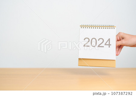 2024 Year Calendar on table background. Happy New Year, Resolution, Goals, Plan,  Action, Mission and financial Concept 107387292