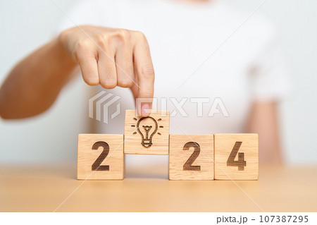 2024 block with lightbulb. Business Idea, Creative, Thinking, brainstorm, Goal, Resolution, strategy, plan, Action, change and New Year start concepts 2024 block with lightbulb. Business Idea, Creative, Thinking, brainstorm, Goal, Resolution, strategy, plan, Action, change and New Year start concepts 107387295