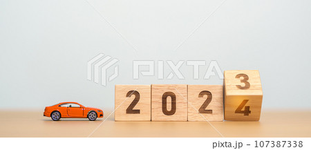 2023 flipping to 2024 year block with car model on table. Automobile Tax, Car Insurance, Financial, vehicle Repair and Maintenance and New Year concept 2023 flipping to 2024 year block with car model on table. Automobile Tax, Car Insurance, Financial, vehicle Repair and Maintenance and New Year concept 107387338