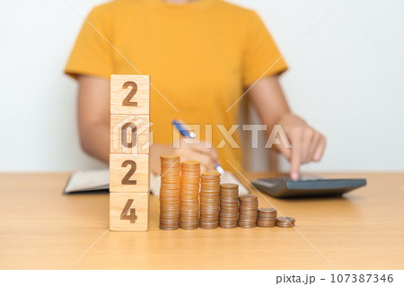 2024 year block with Coins stack. Money, Budget, tax, investment, financial, savings and New Year Resolution concepts 107387346
