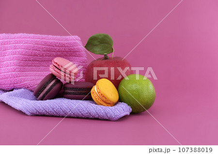 Group of colorful French macaroons and fruits Group of colorful French macaroons and fruits 107388019