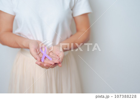 woman holding Purple Ribbon for Stomach, Violence, Pancreatic, Esophageal, Testicular cancer, Alzheimer, epilepsy, lupus, Sarcoidosis and Fibromyalgia. Awareness month and World cancer day concept woman holding Purple Ribbon for Stomach, Violence, Pancreatic, Esophageal, Testicular cancer, Alzheimer, epilepsy, lupus, Sarcoidosis and Fibromyalgia. Awareness month and World cancer day concept 107388228