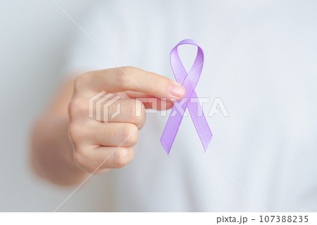 woman holding Purple Ribbon for Stomach, Violence, Pancreatic, Esophageal, Testicular cancer, Alzheimer, epilepsy, lupus, Sarcoidosis and Fibromyalgia. Awareness month and World cancer day concept woman holding Purple Ribbon for Stomach, Violence, Pancreatic, Esophageal, Testicular cancer, Alzheimer, epilepsy, lupus, Sarcoidosis and Fibromyalgia. Awareness month and World cancer day concept 107388235