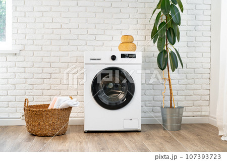 Washing machine and basket in a laundry room 107393723