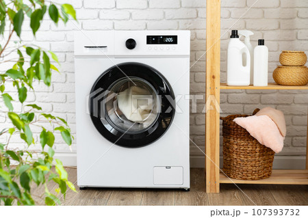 Modern white washing machine close up photo Modern white washing machine close up photo 107393732