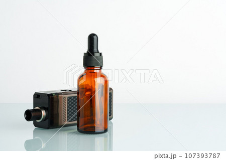 Electronic cigarette with smoking liquid bottle on white background Electronic cigarette with smoking liquid bottle on white background 107393787