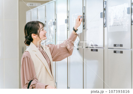 駅・商業施設のコインロッカーに荷物を預ける女性 107393816