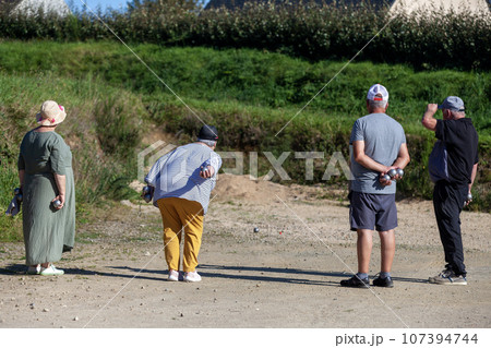 Senior petanque players during a game Senior petanque players during a game 107394744