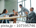 Happy businessman shaking hands at group board meeting. Professional business executive leaders trade partnership handshake concept. 107395746