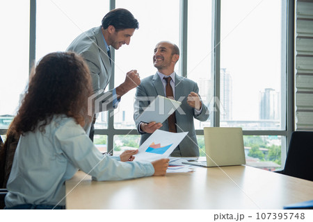 Business man and woman work together, celebrate success in start up office. Creative team brainstorm meeting, businesspeople colleague partnership concept Business man and woman work together, celebrate success in start up office. Creative team brainstorm meeting, businesspeople colleague partnership concept 107395748