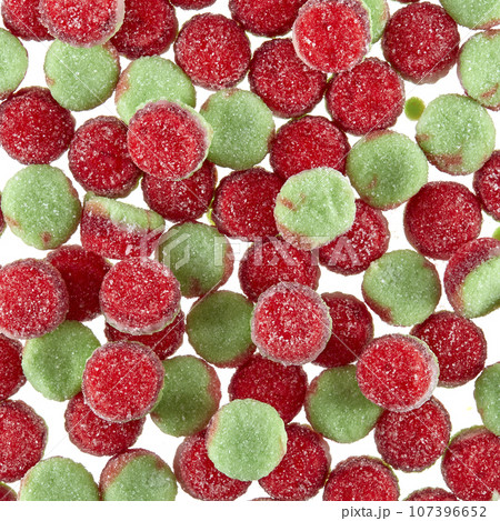 Texture of randomly scattered gelatin candies of red-green colors, in the form of buns sprinkled with sugar. Texture of randomly scattered gelatin candies of red-green colors, in the form of buns sprinkled with sugar. 107396652