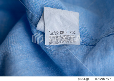 Clothing label on light blue garment, top view Clothing label on light blue garment, top view 107396757