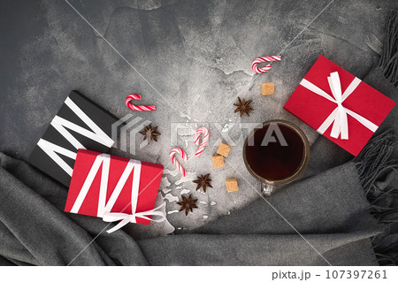 Christmas concept with coffee cup, candy, sugar and gifts on gray. Flat lay 107397261