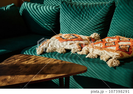 Living room interior with green sofa and coffee table with sunlight. Place for relax at cozy home. 107398291