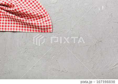 top view with red empty kitchen napkin isolated on table background. Folded cloth for mockup with copy space, Flat lay. Minimal style top view with red empty kitchen napkin isolated on table background. Folded cloth for mockup with copy space, Flat lay. Minimal style 107398830