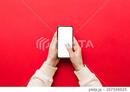 Top view of woman hands holding smart phone with blank copy space screen for your text message or information content. woman hand using phone white screen on top view Top view of woman hands holding smart phone with blank copy space screen for your text message or information content. woman hand using phone white screen on top view 107399025