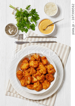 crispy fried panko breaded chicken bites in bowl 107399562